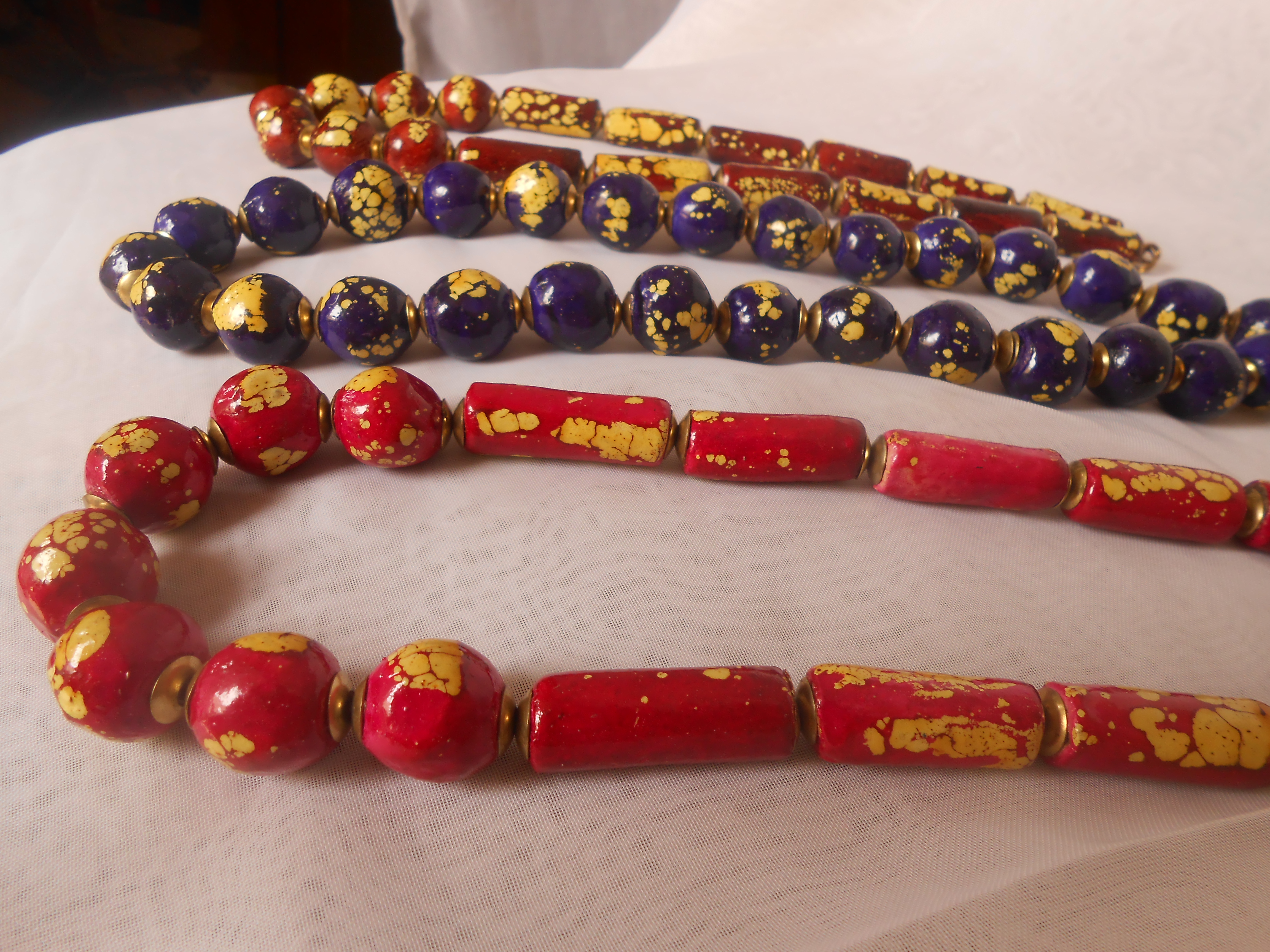 Necklaces made of big hand painted clay beads